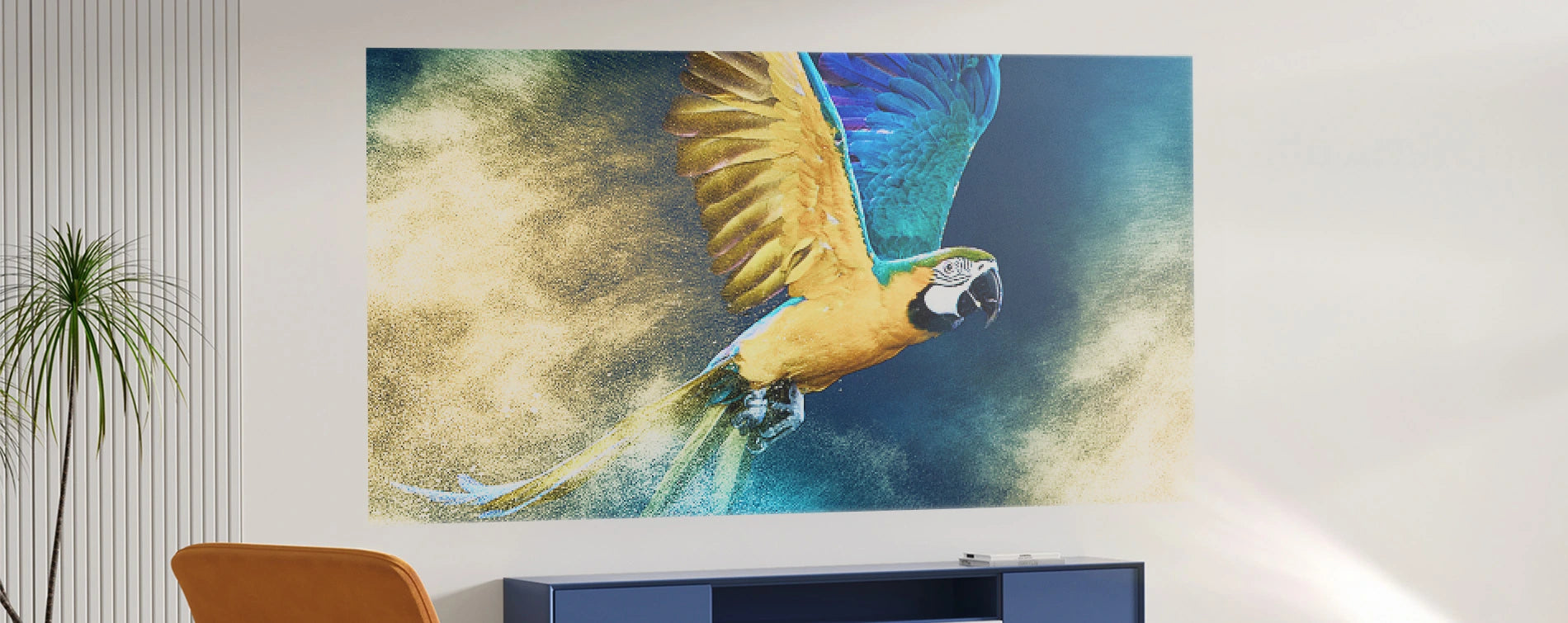 Wall mural of a parrot in flight on a white wall with a plant and chair in the foreground.