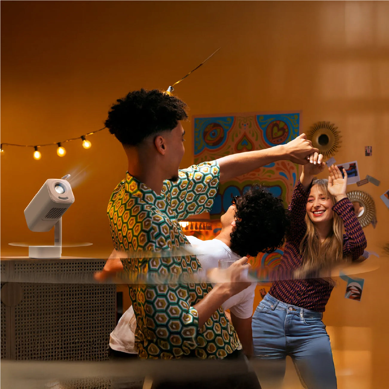 People dancing in a room with a Yaber T1 projector