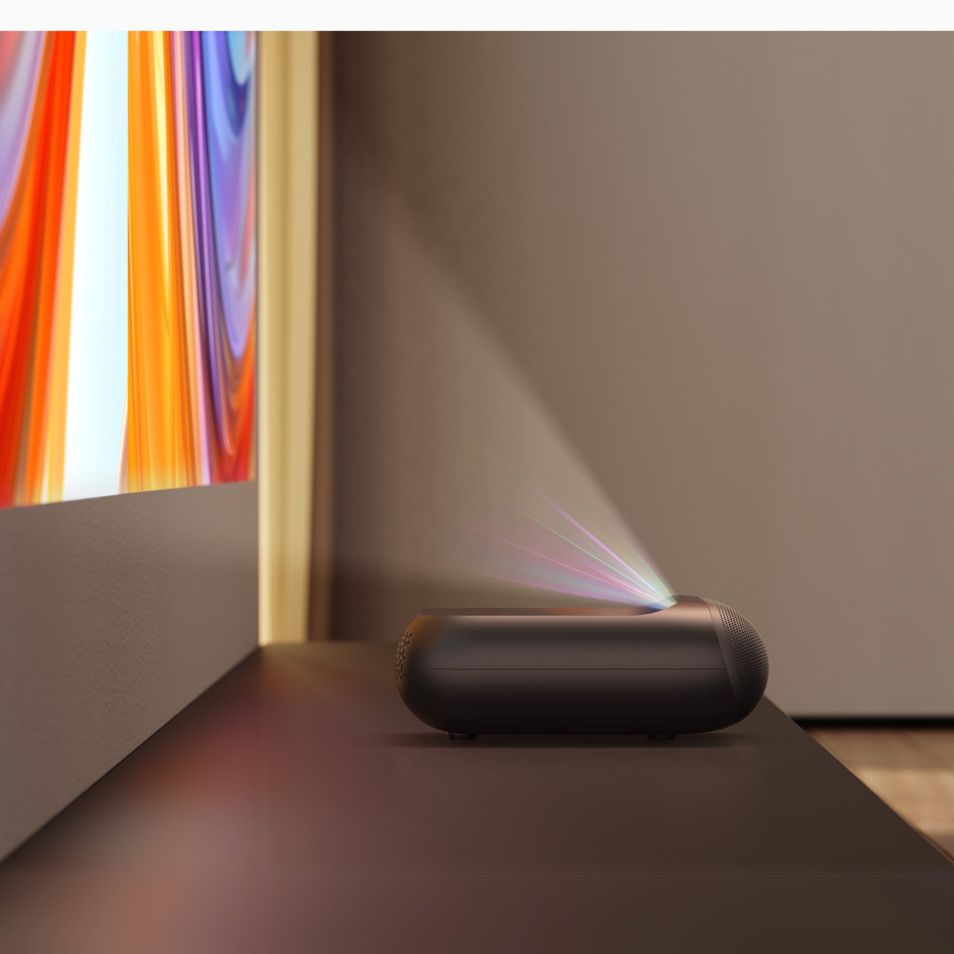 Small black projector on a table with a colorful screen in the background