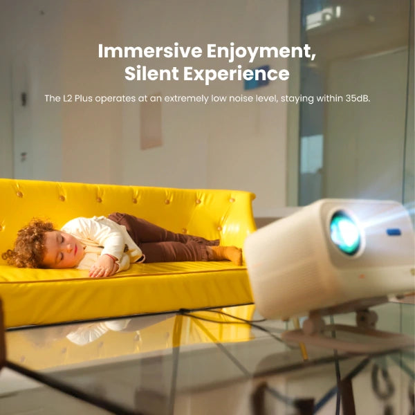 Child lying on a yellow couch with Yaber L2 projector displaying 'Immersive Enjoyment, Silent Experience' text.