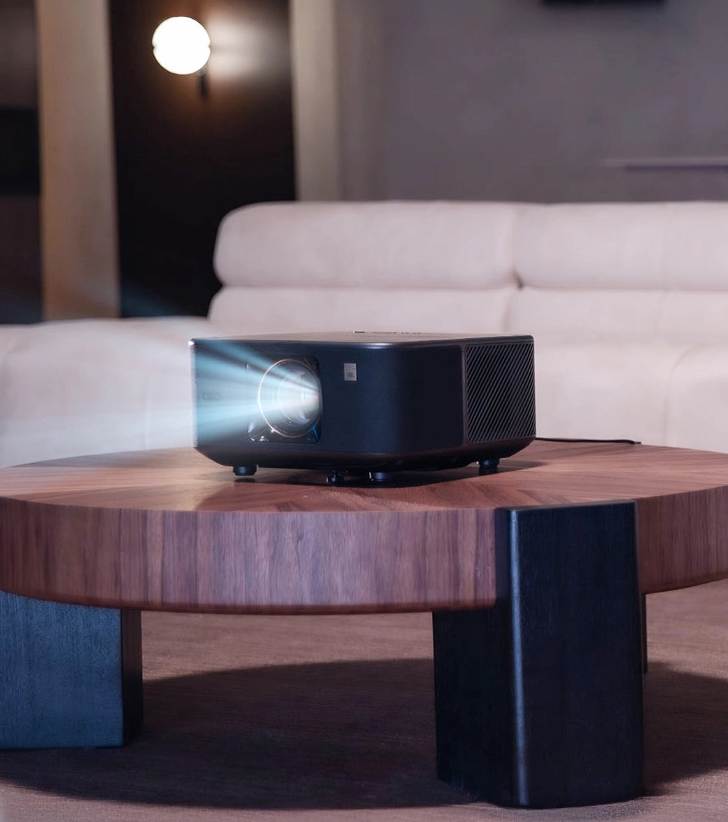 Yaber Projector on a wooden coffee table with a blurred background